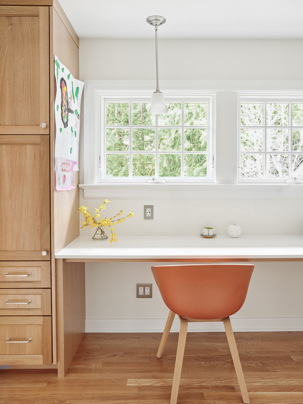 Built-in desk with white countertop and windows overlooking garden, oak storage cabinet at left, Arlington Heights Remodel by Tweto Architecture