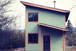 New modern home in the Columbia River Gorge, green board siding with a shed roof, Cascade Locks, by Tweto Architecture