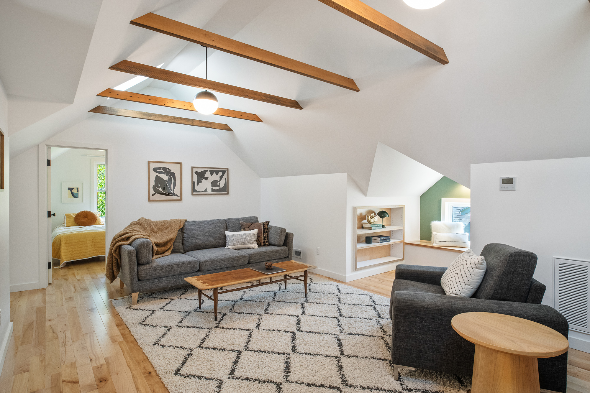 Vaulted attic living space with exposed Douglas Fir collar ties, skylights, and birch floors, NE 9th Remodel by Tweto Architecture, NE Portland