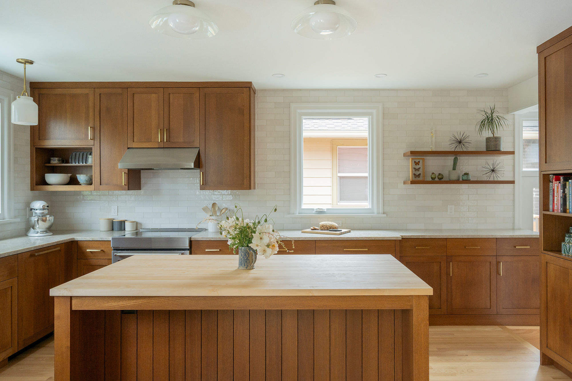 Range wall with vent hood, open shelves, and window above the counter, white oak island in the foreground, Rose City Kitchen by Tweto Architecture