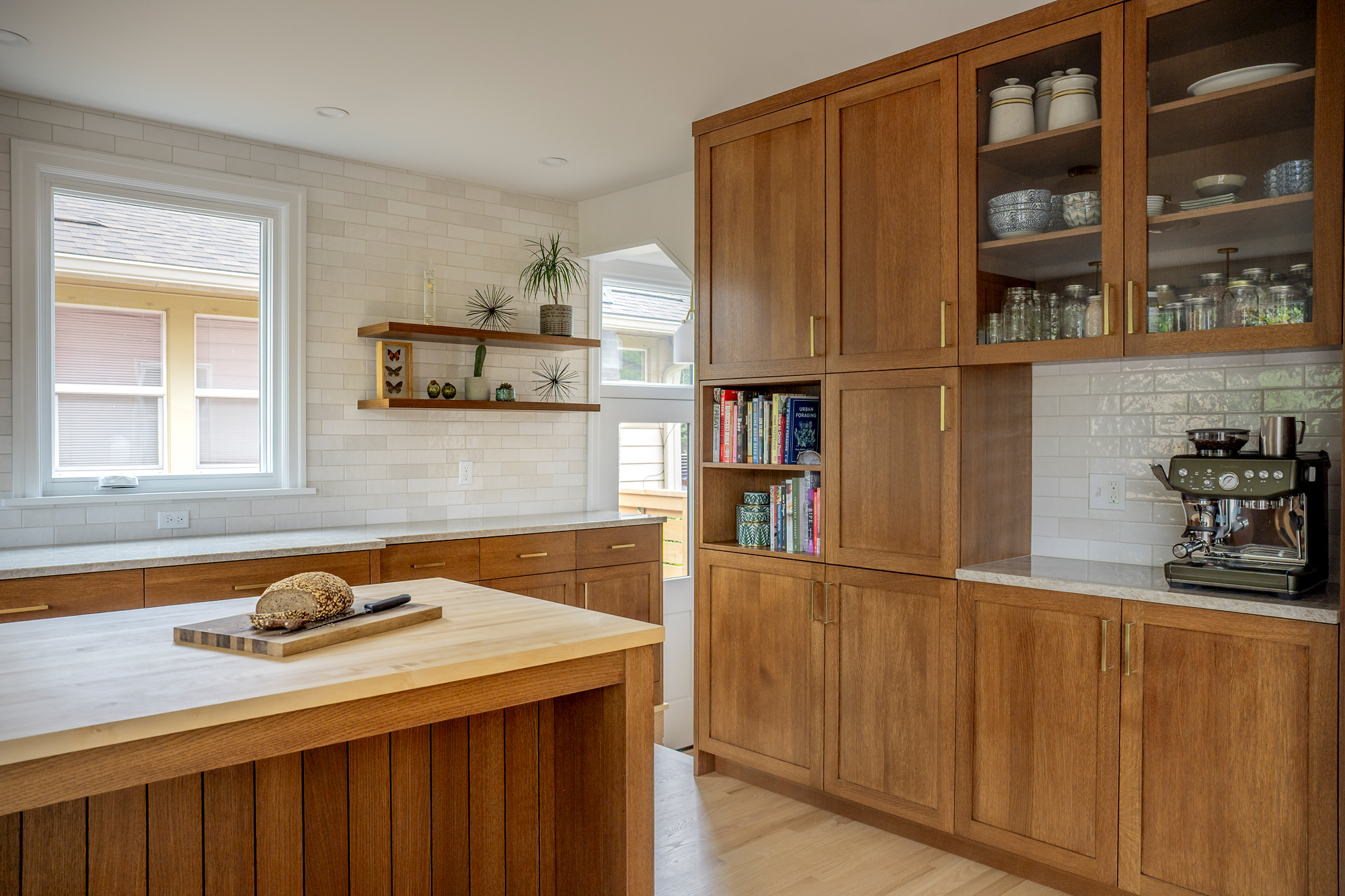 Coffee station and pantry built-in with glass-front cabinets above, espresso machine on the quartzite counter, Rose City Kitchen by Tweto Architecture