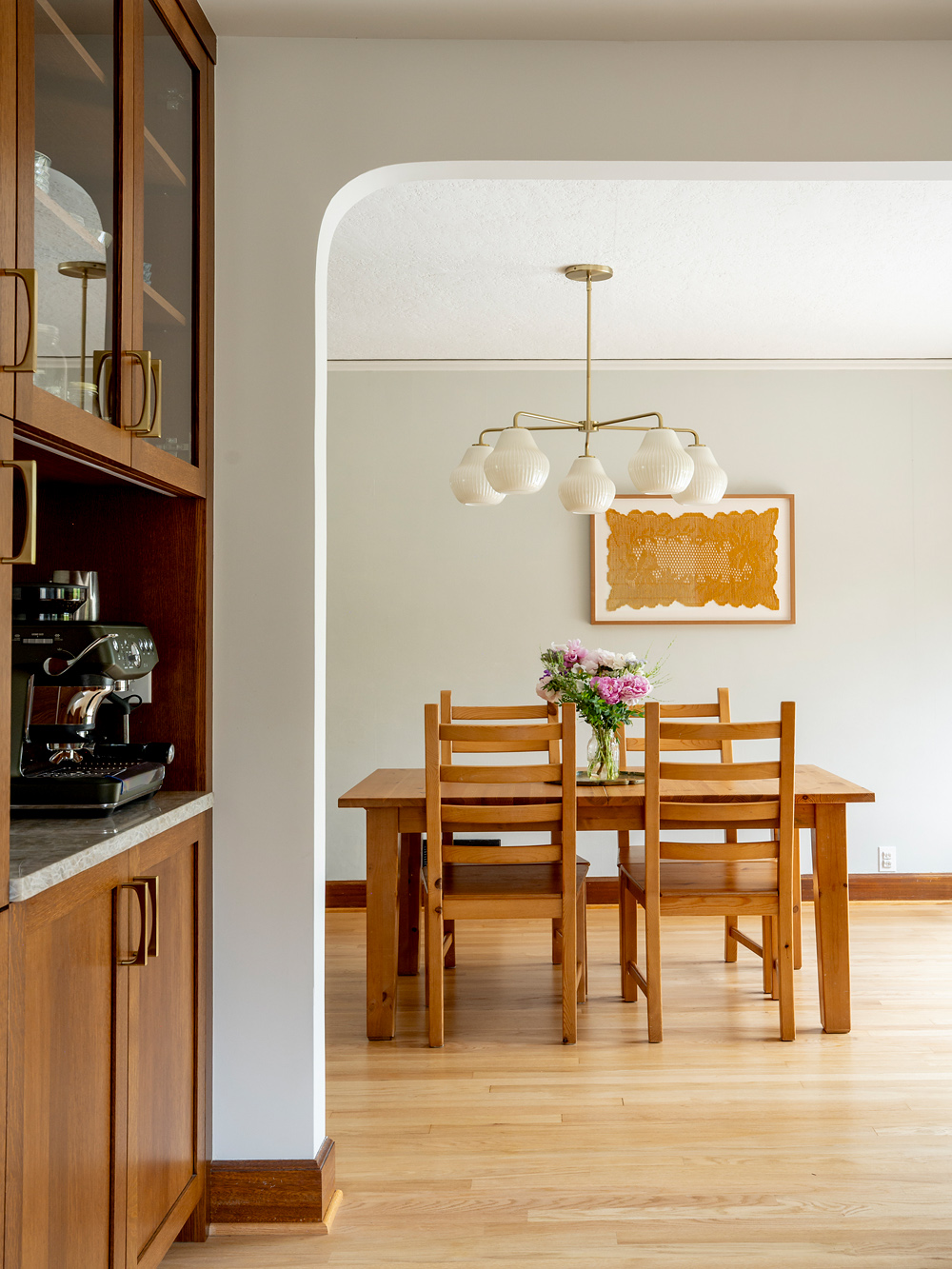 Arched opening between kitchen and dining room detailed to match the other openings in the home, coffee station at left, Rose City Kitchen by Tweto Architecture